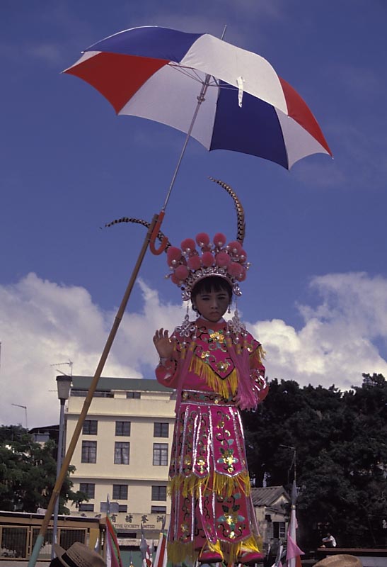 umbrella shading girl in bun festival parade
